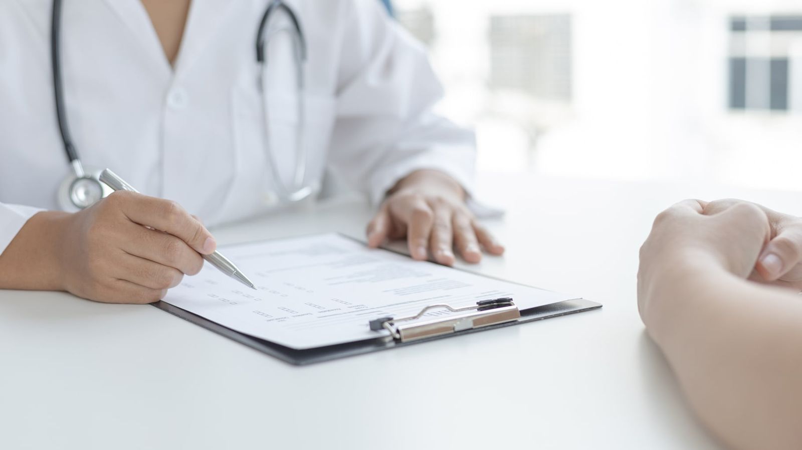 Practitioner taking notes during a wellness consultation